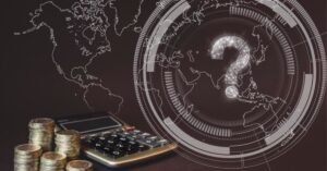 Stacks of coins and calculator with digital world map symbolizing global Economic Uncertainty trends.